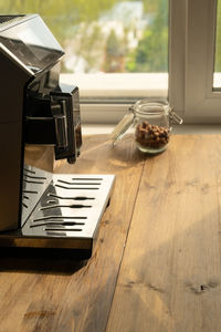 Automatic coffee machine for black coffee near window at daytime in a coffee shop, cafe, restaurant