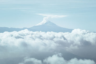 Majestic view of clouds covering snowcapped mountain