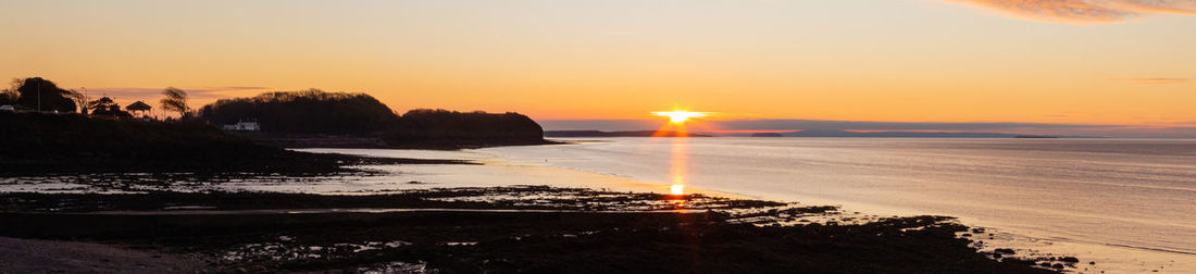 Scenic view of sea against orange sky during sunset