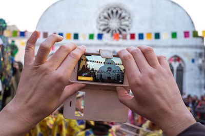 Close-up of cropped hand holding mobile phone