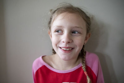 Laughing blonde girl with french braids looks off camera