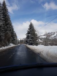 Road seen through car windshield during winter