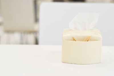 Close-up of white bottle on table