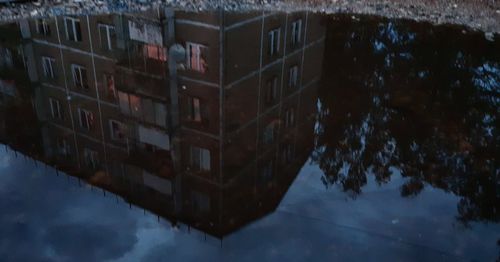 Reflection of building on puddle