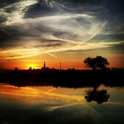 Reflection of clouds in water at sunset