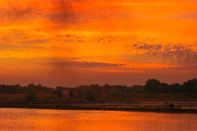 Scenic view of lake against romantic sky at sunset