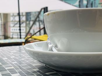 Close-up of white coffee cup on table