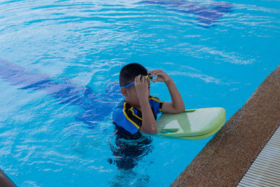 High angle view of boy in swimming pool
