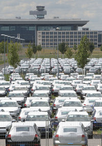 Cars in parking lot by buildings in city