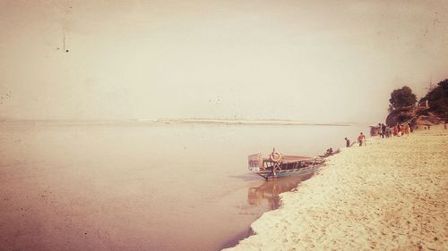 People on beach against sky