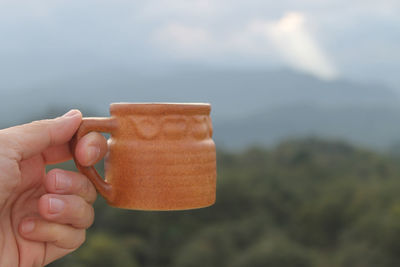 Close-up of hand holding ice cream cone