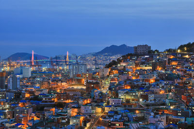 High angle view of illuminated buildings against sky at dusk