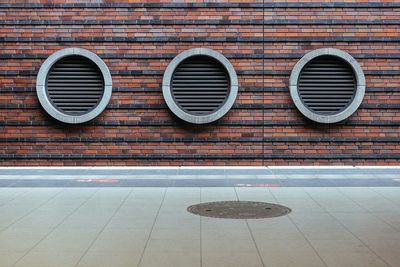 Close-up of air ducts on brick wall