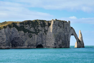 The cliffs of etretat with it natural arch - pont daval - and its needle - aiguille d'etretat -