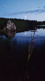 Reflection of trees in lake against sky