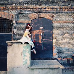 Full length of woman walking on sidewalk