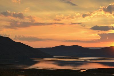 Scenic view of lake against sky during sunrise