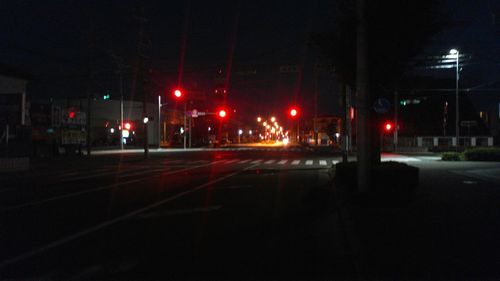 Illuminated road in city at night