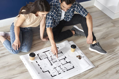 High angle view of people sitting on table