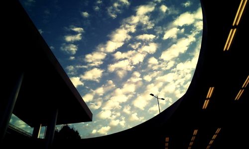 Low angle view of building against cloudy sky