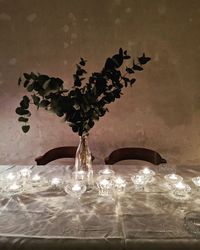 Close-up of flower vase on glass table