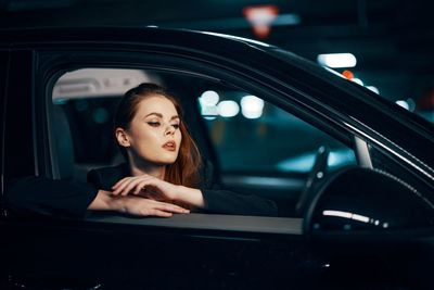 Portrait of young woman in car