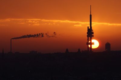 Silhouette built structure against sky at sunset