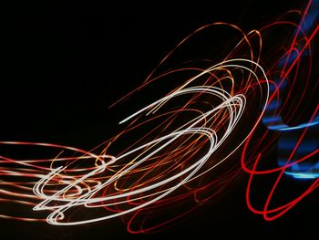 Light trails against black background