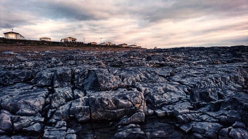 Rock formations on land against sky during sunset