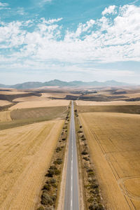 Scenic view of land road against sky