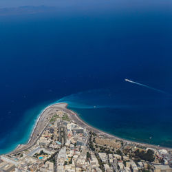 High angle view of sea and buildings against sky