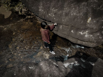 High angle view of people walking on rock