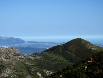 Scenic view of mountains against clear blue sky