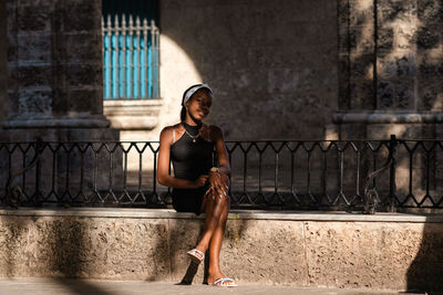 Portrait of a smiling young woman in city