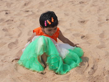 High angle view of woman standing at sandy beach