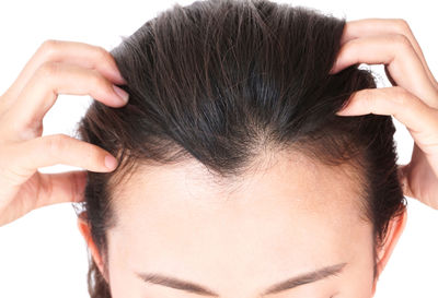 Close-up of beautiful young woman over white background