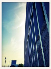 Low angle view of modern building against blue sky