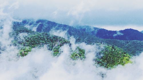 Scenic view of waterfall against sky