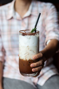 Midsection of man holding drink