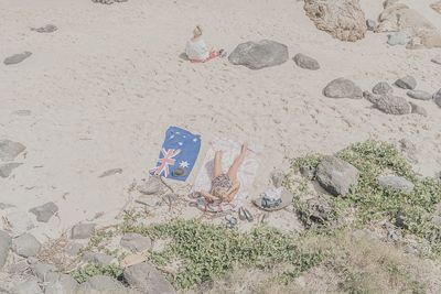 High angle view of child playing on sand at beach