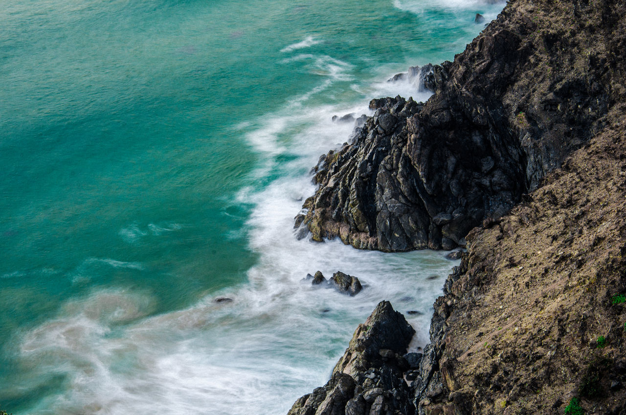 sea, rock, rock - object, solid, water, motion, beauty in nature, no people, rock formation, wave, land, nature, beach, power in nature, day, sport, aquatic sport, power, outdoors, hitting, breaking, rocky coastline