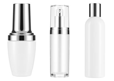 Close-up of perfume sprayers over white background