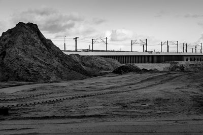 Tire tracks on dirt against sky