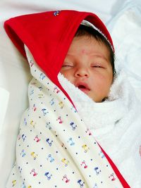 High angle view of cute baby boy on bed