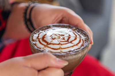 Close-up of woman holding coffee cup