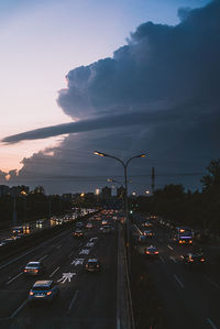 Traffic on road at sunset