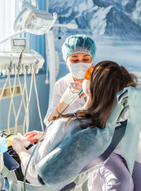 Dentist examining teeth of patient