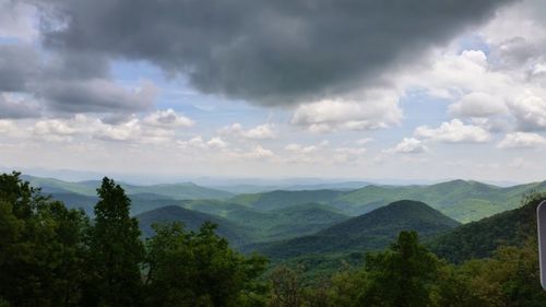 Scenic view of mountains against cloudy sky