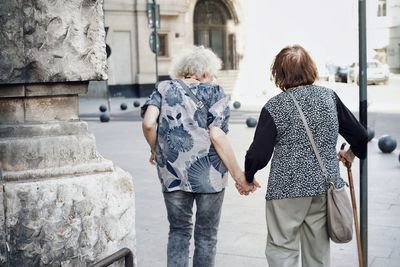 Rear view of women walking on street