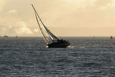 Ship sailing on sea against sky